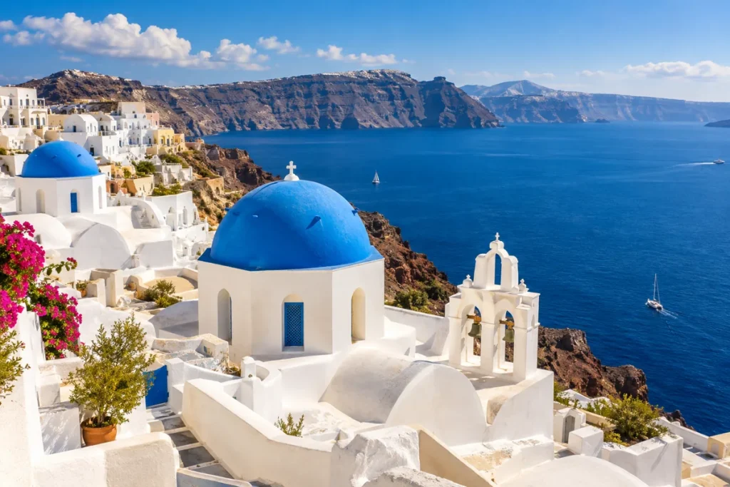 Illustrative white buildings and blue domes overlooking the sea