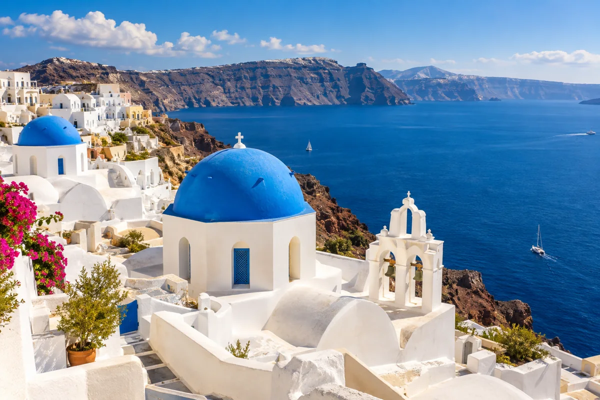 Whitewashed buildings and blue domes above the sea